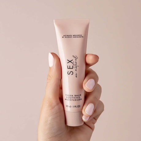Sex Au Naturel Vulva Balm Soothing Moisturizer in a hand, showcasing its soothing packaging for intimate care.