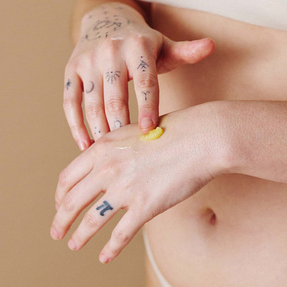 Applying Sex Au Naturel Vulva Balm Soothing Moisturizer on the skin for hydration and comfort.