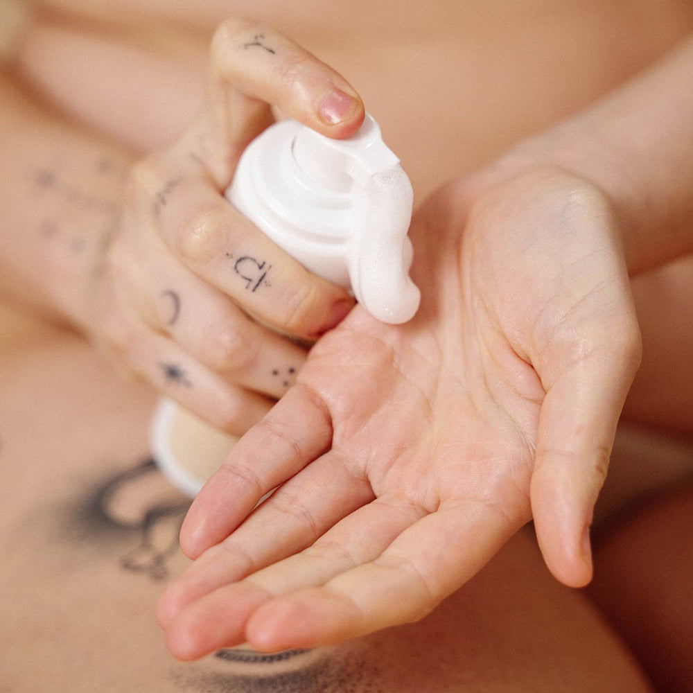 Sex Au Naturel Prebiotic Intimate Wash Gentle Foam being dispensed into a hand for gentle cleansing.