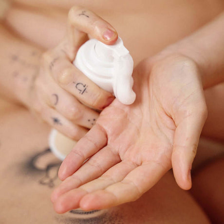 Sex Au Naturel Prebiotic Intimate Wash Gentle Foam being dispensed into a hand for gentle cleansing.
