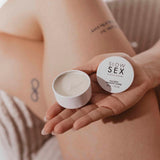 Bijoux Indiscrets Slow Sex Massage Candle in a hand, showcasing a sensual massage experience.