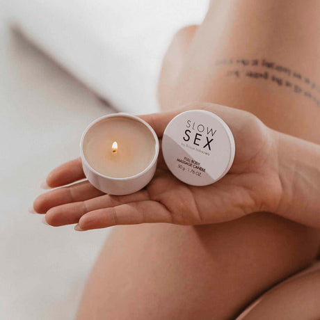 Bijoux Indiscrets Slow Sex Massage Candle in hand, ready for a sensual massage experience.
