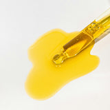 Slow Sex Anal Soothing Oil Before And After Care dropper with golden oil on a white surface.