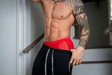 Male Power Mesh 2.0 Mini Short Red XL worn by a tattooed man showcasing comfort and sporty style.