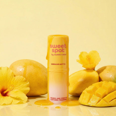 Sweetums Sweet Spot Flavored Fragrance Hibiscus Hottie with mango and hibiscus against a bright yellow background.