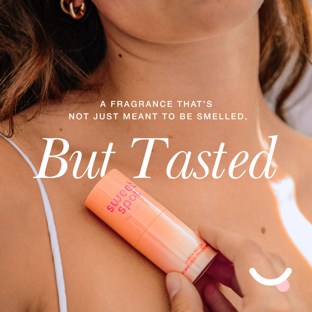 Sweetums Sweet Spot Flavored Fragrance Hibiscus Hottie solid fragrance stick on skin with a tropical flavor.