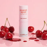 Sweetums Sweet Spot Flavored Fragrance Cherry Bombshell with cherries on a pink background, showcasing the playful scent.