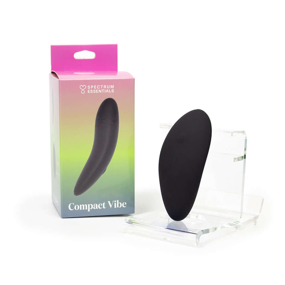 Spectrum Essentials Compact External Vibrator Black displayed with packaging on a clear stand.