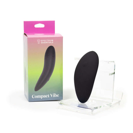 Spectrum Essentials Compact External Vibrator Black displayed with packaging on a clear stand.