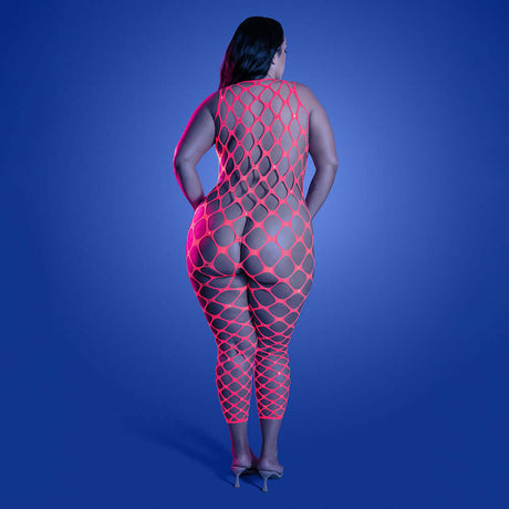 Model showcases the Fantasy Lingerie Glow Want It All Bodystocking Queen in neon pink against a bold blue backdrop.