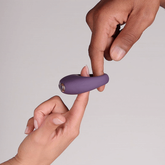 Je Joue Mio V2 Vibrating Cock Ring Blue being held by two hands, showcasing its design and texture.