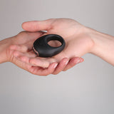Je Joue Mio V2 Vibrating Cock Ring Black held in a hand, showcasing its sleek design and functionality.
