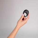 Je Joue Mio V2 Vibrating Cock Ring Black held in hand against a neutral background.