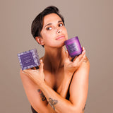 Je Joue Purple Vanilla Massage Candle 160g displayed by a woman holding the candle and packaging.