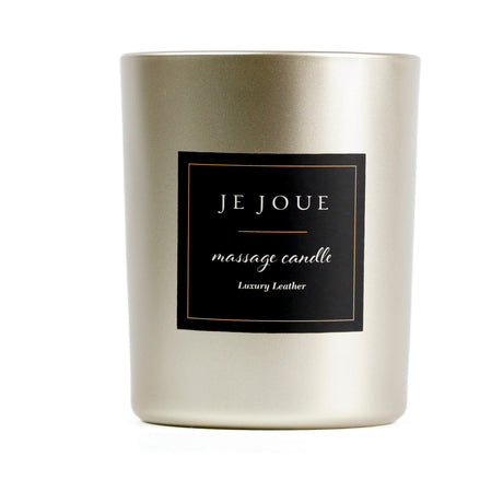 Je Joue Luxury Leather Massage Candle 160g in an elegant gold holder, perfect for a sensual evening.