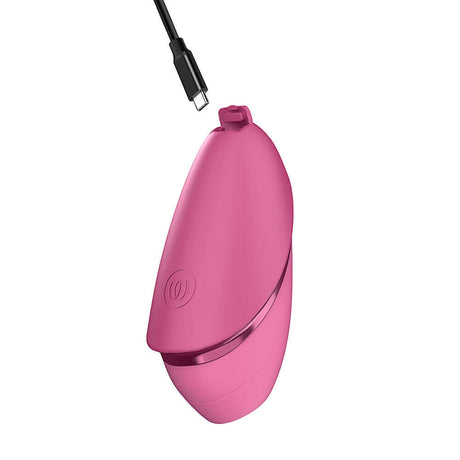 Womanizer Next Liberty Air Clitoral Massager Vibrant Pink charging with USB cable.