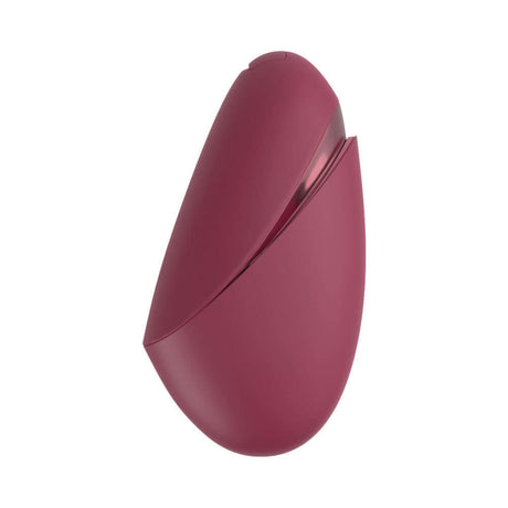 Womanizer Next Liberty Air Clitoral Massager Bordeaux in burgundy color, compact design with travel cap.
