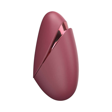 Womanizer Next Liberty Air Clitoral Massager Bordeaux in sleek bordeaux design with travel cap for convenient use.