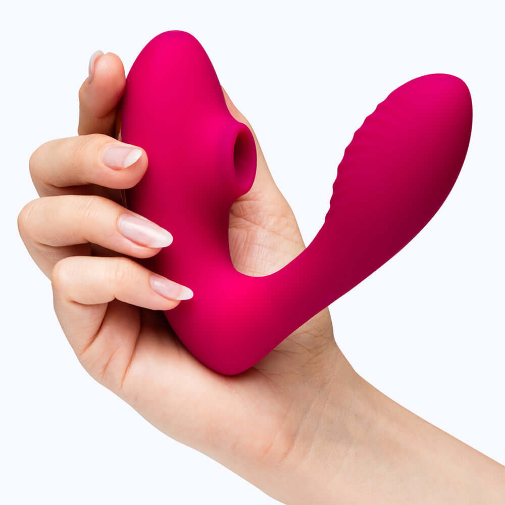 Lovehoney Indulge Advent Calendar 2026 (12 Day) vibrant pink toy held in hand against a light background.