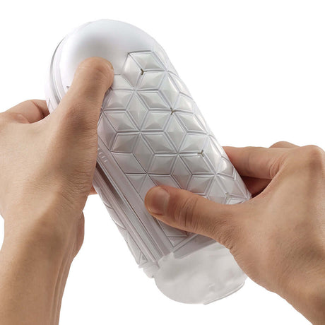 Hand holding the Tenga Flip Flexy Male Stroker showcasing its flexible design for enhanced pleasure.