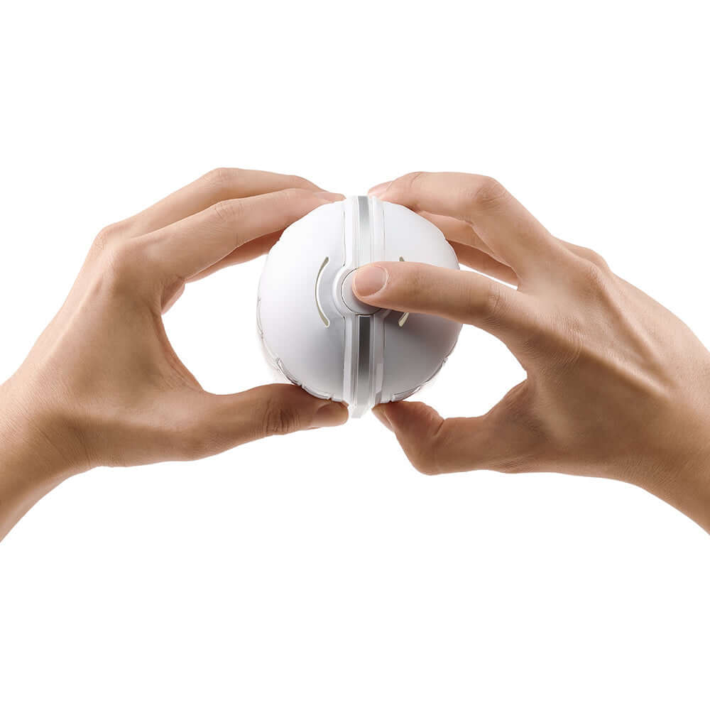 Two hands holding the Tenga Flip Flexy Male Stroker, demonstrating its innovative flexible design.