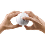 Two hands holding the Tenga Flip Flexy Male Stroker, demonstrating its innovative flexible design.