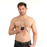 A shirtless man holding the Prowler Red Vibrating Ball Bag, showcasing its design and features.