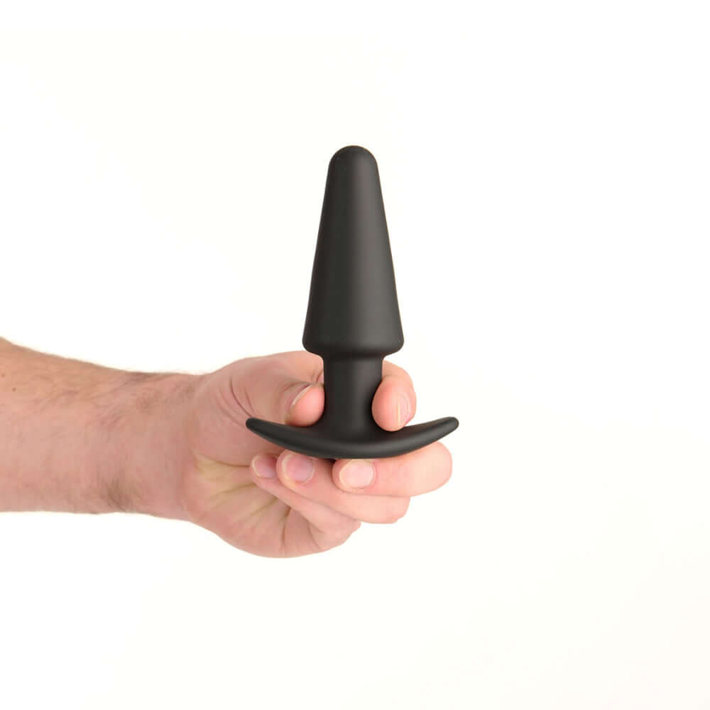Prowler Red Tapered Rechargeable Plug With Remote being held, showcasing its tapered design and flared base.