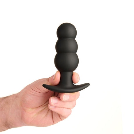 Prowler Red Bubble Rechargeable Plug With Remote held in hand showcasing its sleek design and smooth silicone surface.