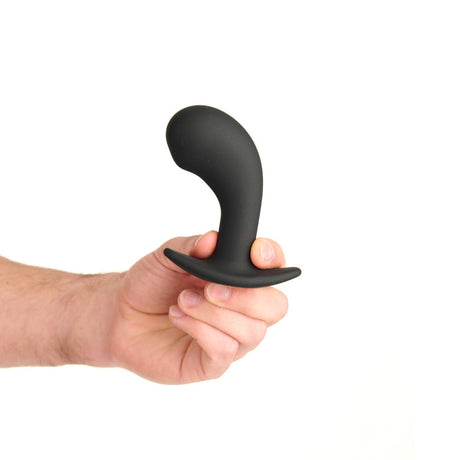 Prowler RED P-Spot Rechargeable Plug with Remote held in hand, showcasing its ergonomic design for P-spot stimulation.