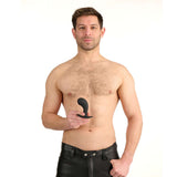 Man holding the Prowler RED P-Spot Rechargeable Plug with Remote, showcasing its ergonomic design.