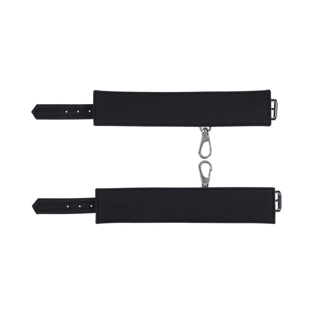 Sportsheets Signature Midnight Muse Ankle Cuffs in sleek black silicone with silver-tone hardware for comfortable restraint play.