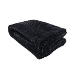 Sportsheets Signature Waterproof Blanket folded and ready for use, showcasing its soft ribbed texture and grommets.