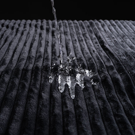 Water splashing on the plush texture of the Sportsheets Signature Waterproof Blanket.