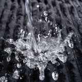 Water splashing on the Sportsheets Signature Waterproof Blanket, demonstrating its protective and waterproof features.
