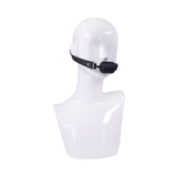 Sportsheets Signature Midnight Muse Barrel Gag on a mannequin head, showcasing its sleek design and luxurious look.