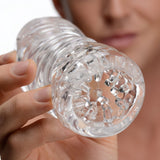 Sexflesh Palm-Tec LX Vol 20 Stroker Clear held up close to showcase its ribbed interior and ergonomic design.