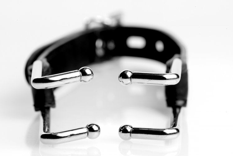 Strict Claw Hook Mouth Spreader Black close-up with metallic claw tips and adjustable strap.