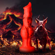 Fire Hound Silicone Dildo Medium stands tall with a vibrant red design in fiery, volcanic surroundings.
