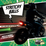 Teeny Weeny Light-Up Silicone Truck Nuts Black on a motorcycle with colorful graphics highlighting stretchy silicone.