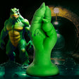 Raptor Claw Fisting Silicone Dildo Green next to a green reptilian creature in a dark environment.