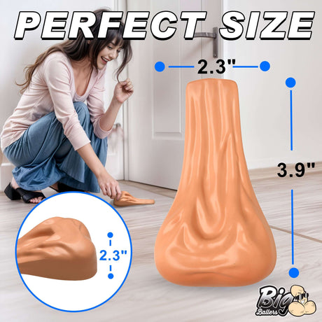 Woman using Big Balls Door Stop measuring 2.3" x 3.9", a humorous door stopper for any environment.