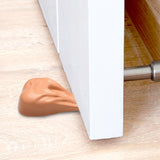 Big Balls Door Stop wedged under a door, providing a humorous and functional door-stopping solution.