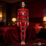 Master Series Backbone Full Body Harness Black worn by a model in a provocative pose on a bed.
