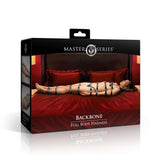 Image of Master Series Backbone Full Body Harness Black packaging, showcasing the product on a red bed.