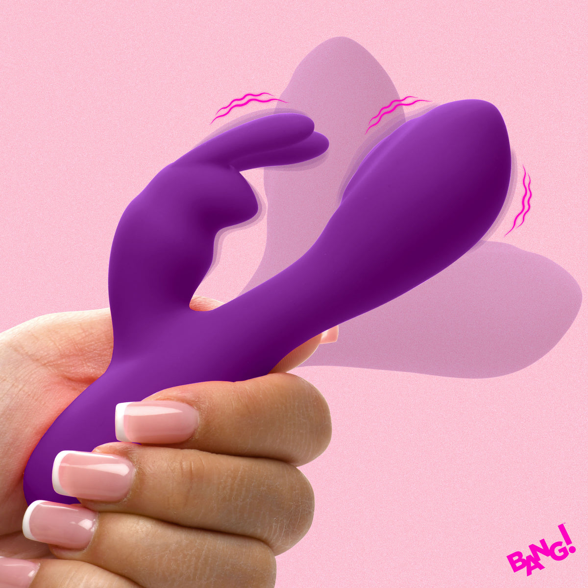 Flexible Vibrating Silicone Mini Rabbit Purple held in hand against a pink background.