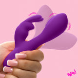 Flexible Vibrating Silicone Mini Rabbit Purple held in hand against a pink background.