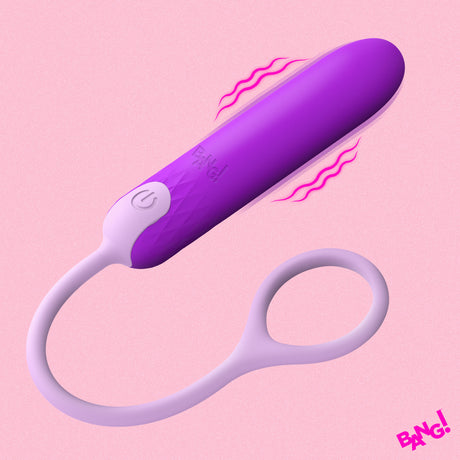 Bang Silicone Bullet with Cord Purple on a pink background, featuring a sleek design and powerful vibrations.