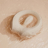 ZALO Apis Vibrating Couples Ring Ivory White resting in water, showcasing its sleek design and body-safe silicone.