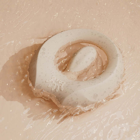 ZALO Apis Vibrating Couples Ring Ivory White resting in water, showcasing its sleek design and body-safe silicone.